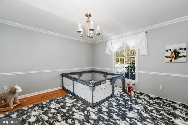 a living room with a couch and a chandelier