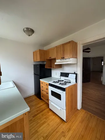 a kitchen with stainless steel appliances a stove a microwave and white cabinets