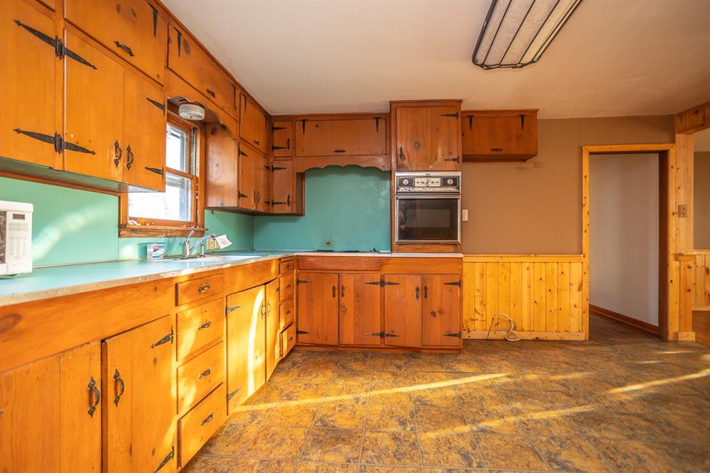 1414 Rice Avenue Gainesville, TX 76240 - Photo 6 of 21 a view of a kitchen with stainless steel appliances granite countertop a sink and cabinets