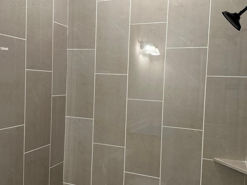 585 Brown Road Leonard, TX 75452 - Photo 8 of 29 Shower featuring large format gray wall tiling, a matte black shower head, and a built-in corner shelf