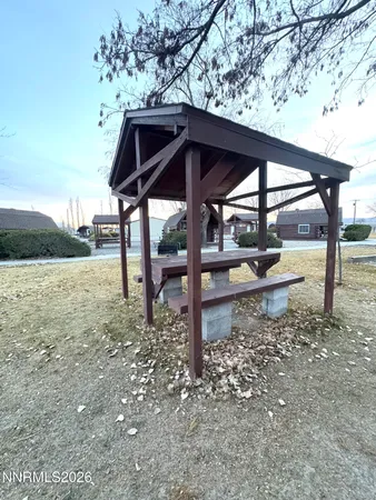 a backyard of a house with table and chairs