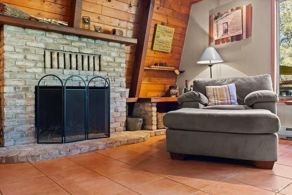 a living room with furniture and a floor to ceiling window