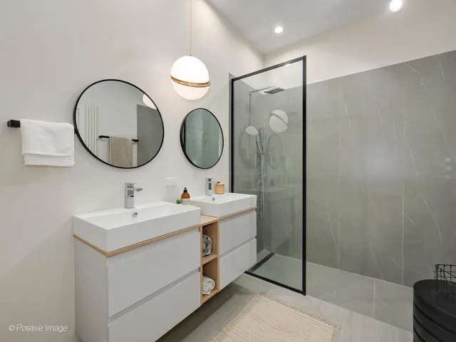 a bathroom with a sink mirror and vanity