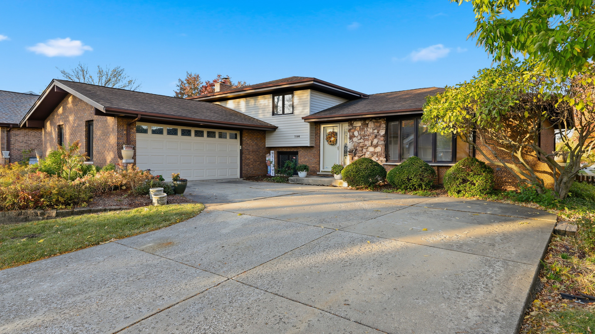a front view of a house with a yard and a garage