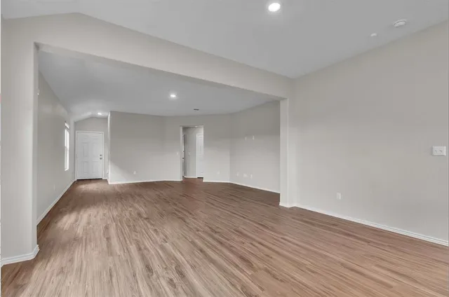 a view of an empty room and wooden floor
