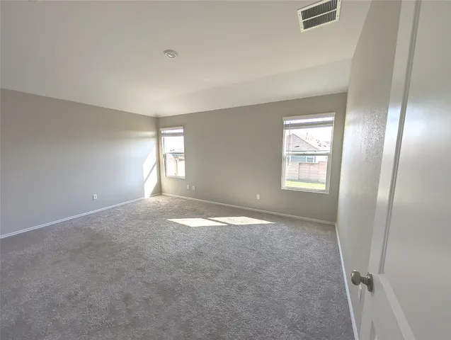an empty room with windows and closet