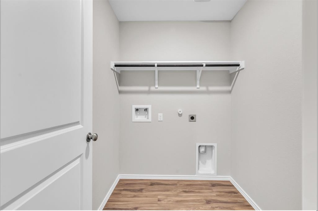 240 Madrid Kyle, TX 78640 - Photo 19 of 25 Washroom with hookup for an electric dryer, hookup for a washing machine, wood finished floors, and gas dryer hookup