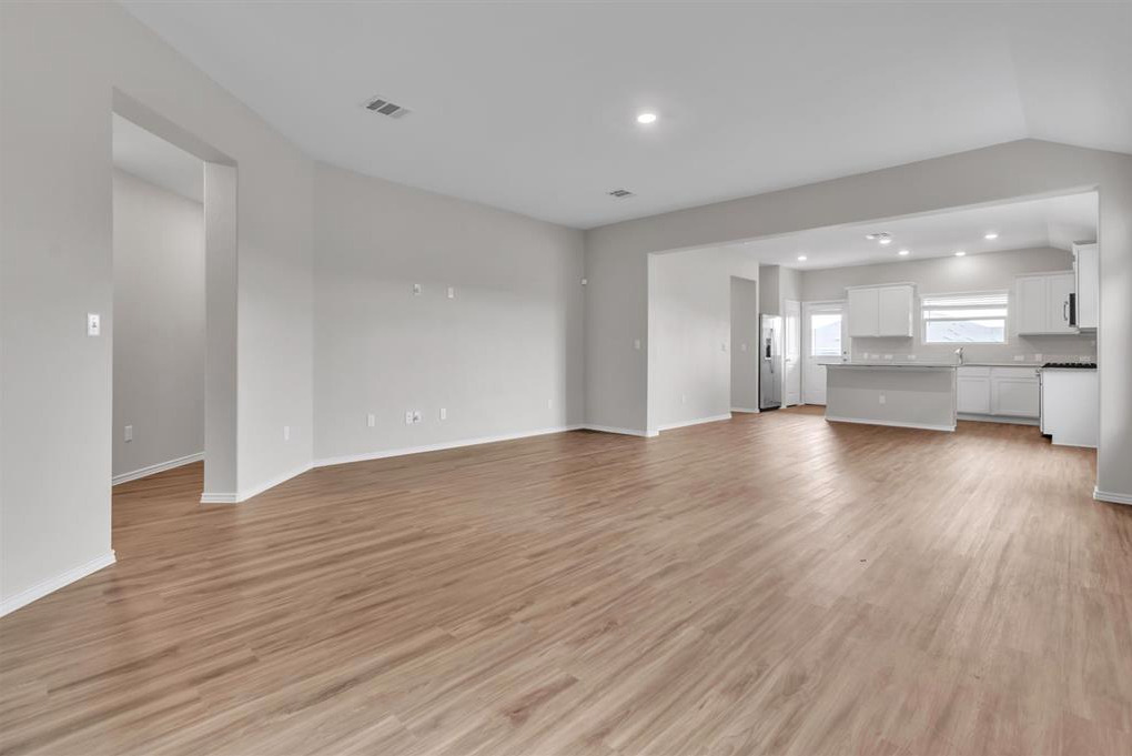 240 Madrid Kyle, TX 78640 - Photo 5 of 25 Unfurnished living room with light wood-style flooring, recessed lighting, and lofted ceiling