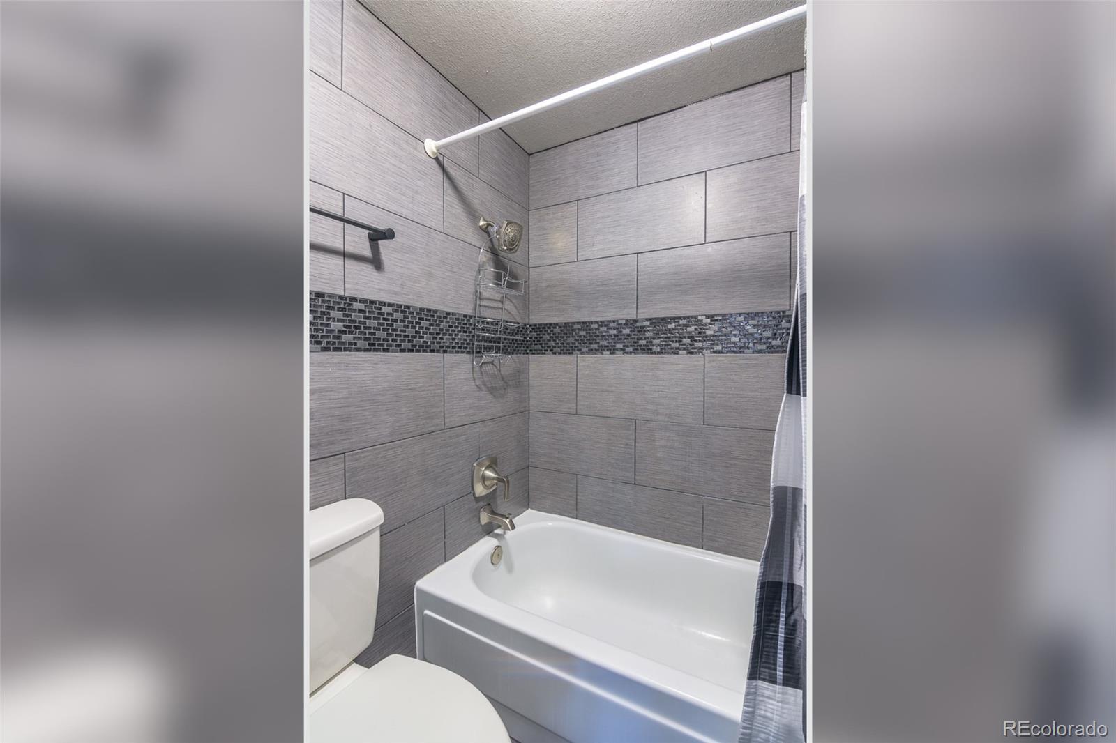 1304 South Parker Road, Unit 347 Denver, CO 80231 - Photo 11 of 27 a bathroom with a shower a toilet and sink