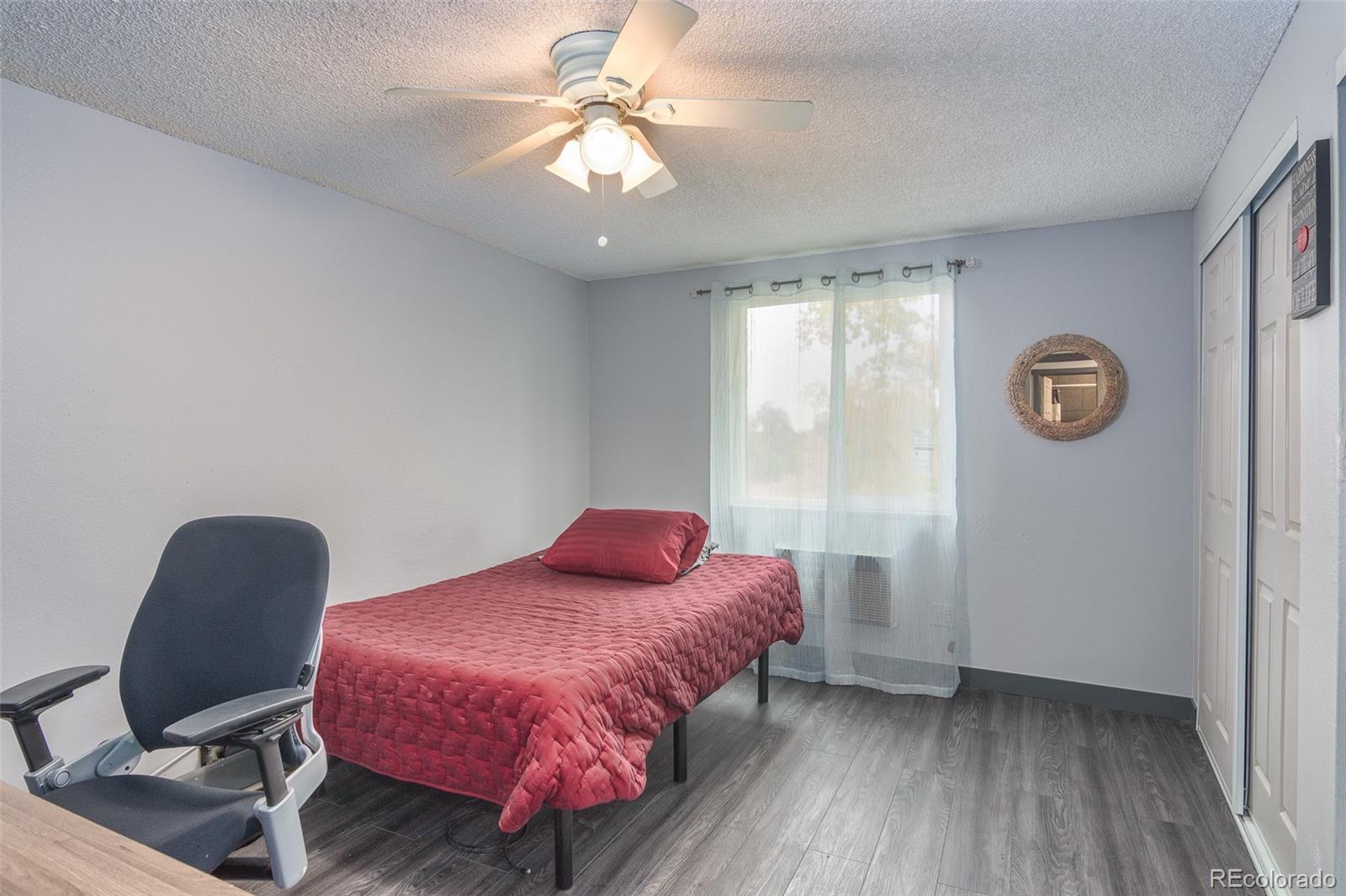 1304 South Parker Road, Unit 347 Denver, CO 80231 - Photo 12 of 27 a bedroom with a bed a window and chair