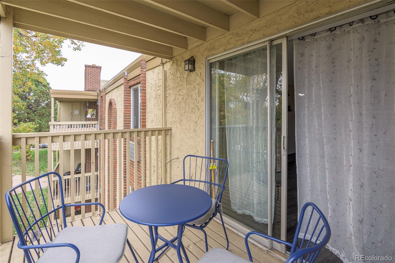 1304 South Parker Road, Unit 347 Denver, CO 80231 - Photo 16 of 27 a view of a balcony with a table and chairs