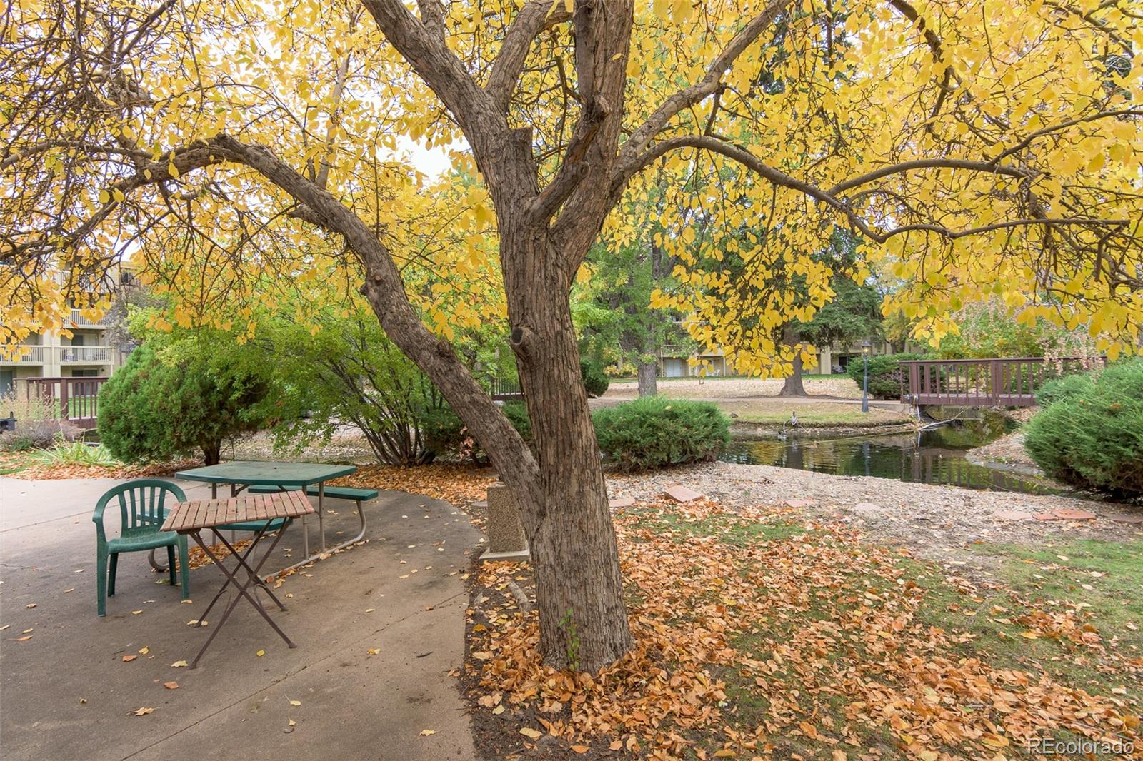 1304 South Parker Road, Unit 347 Denver, CO 80231 - Photo 20 of 27 a backyard of a house with table and chairs
