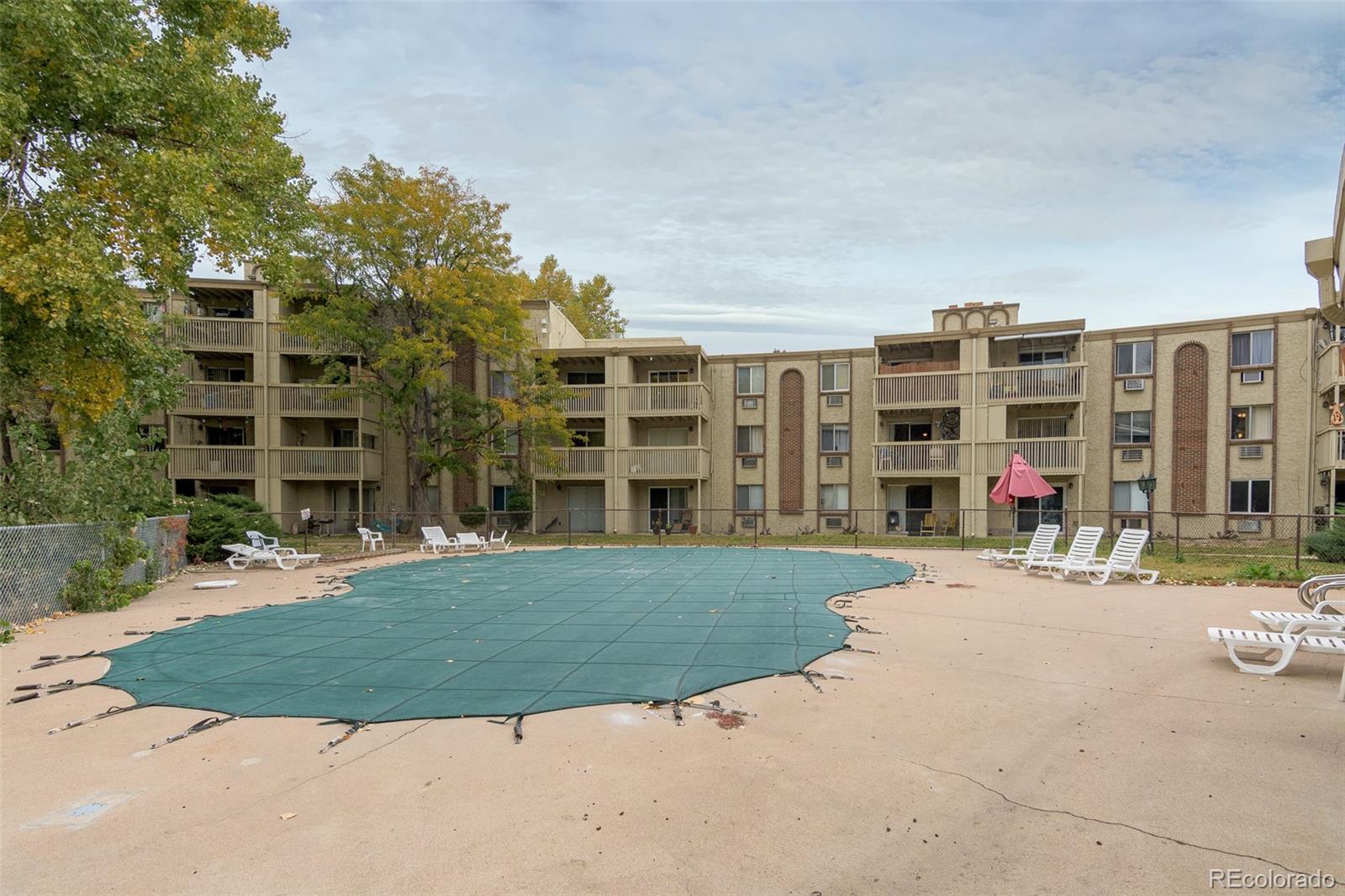1304 South Parker Road, Unit 347 Denver, CO 80231 - Photo 21 of 27 a view of a building with a yard and plants