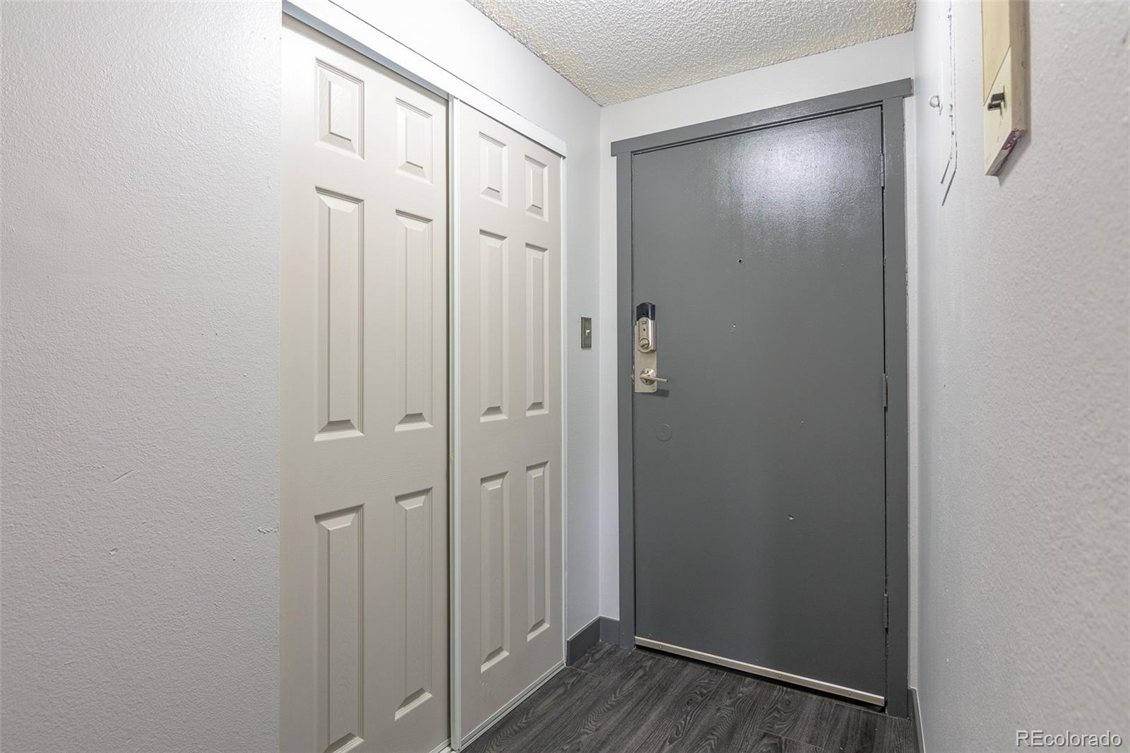 1304 South Parker Road, Unit 347 Denver, CO 80231 - Photo 4 of 27 a view of a hallway with wooden floor