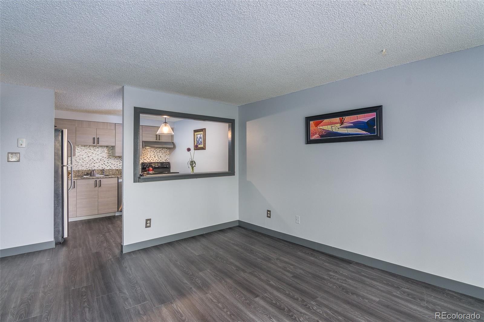 1304 South Parker Road, Unit 347 Denver, CO 80231 - Photo 7 of 27 a view of cabinets and wooden floor