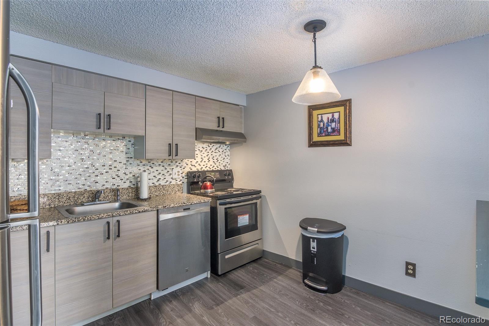 1304 South Parker Road, Unit 347 Denver, CO 80231 - Photo 8 of 27 a kitchen with a stove and a refrigerator