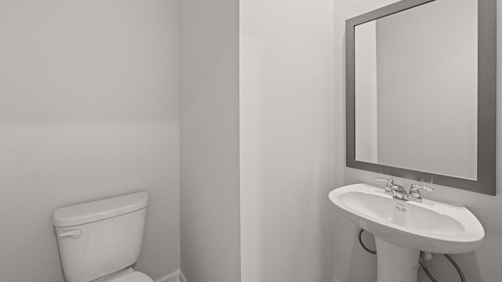 3253 Ryker Road, Unit 304 Gainesville, GA 30507 - Photo 13 of 32 a bathroom with a toilet a sink and a mirror