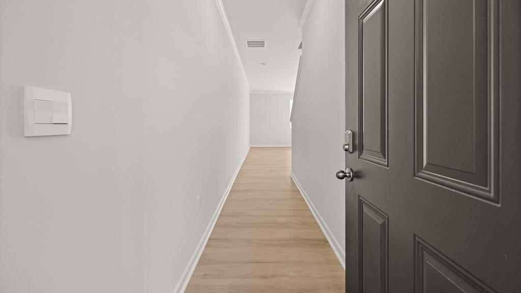 3253 Ryker Road, Unit 304 Gainesville, GA 30507 - Photo 2 of 32 a view of a hallway with wooden floor and staircase
