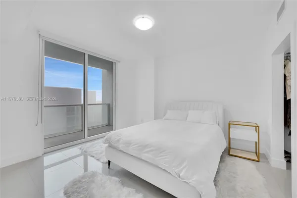 a bedroom with a bed and table