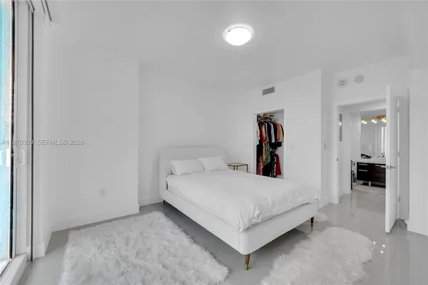 a large white bed in a white room