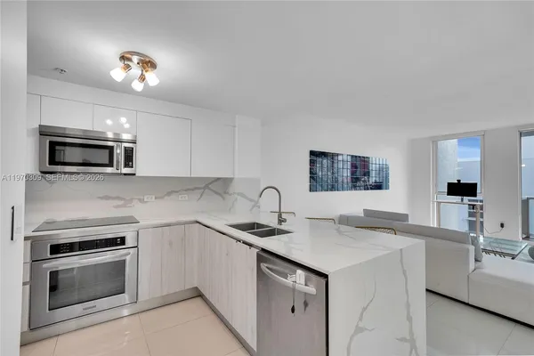 a kitchen with a sink stove and microwave