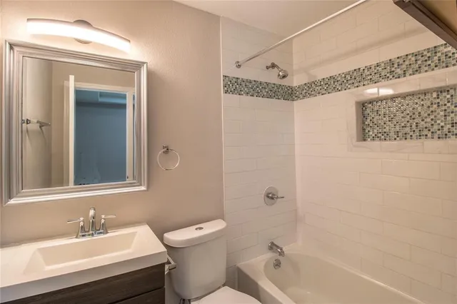 a bathroom with a sink mirror toilet and bathtub