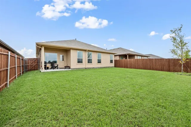 a view of a house with a back yard