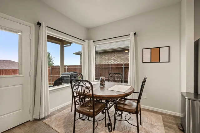 a dining room with furniture and window
