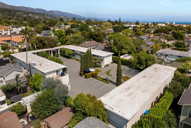 an aerial view of a house with a yard