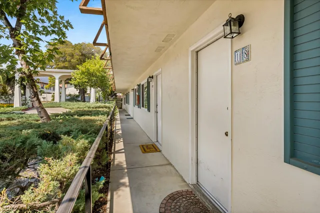 a view of a pathway of a house with a yard