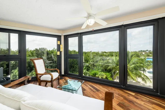 a view of a room with furniture and large windows