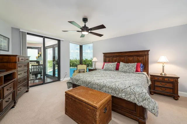 a bedroom with a large bed and a chandelier