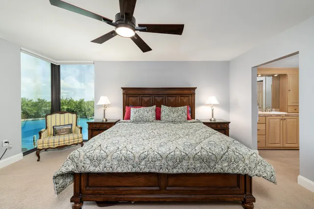 a bedroom with a bed and a large window