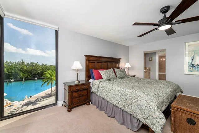 a bedroom with a bed and dresser with chair