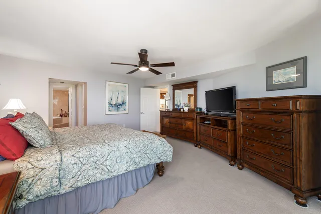 a bedroom with a bed a window and wall painting