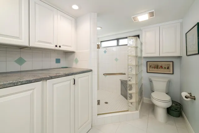 a view of a patio with a table chairs and a small yard
