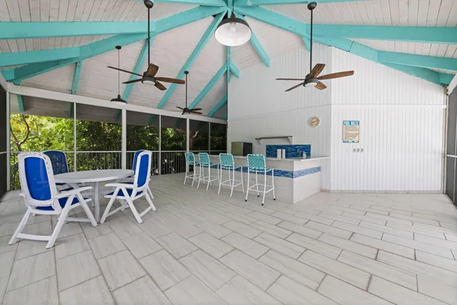 a view of a swimming pool with outdoor seating and plants