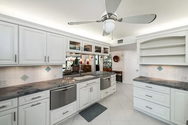 a kitchen with stainless steel appliances granite countertop a stove and cabinets