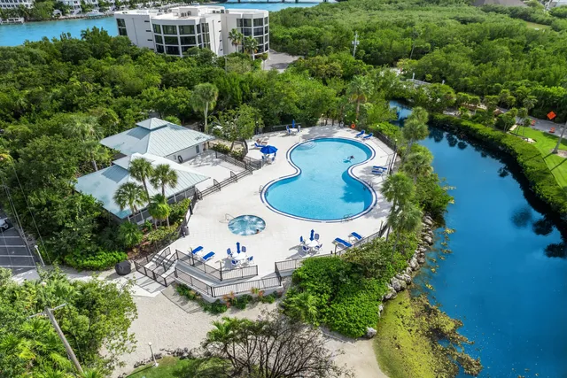 an aerial view of a house with outdoor space and lake view