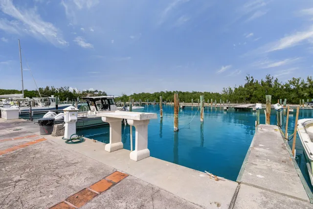 a balcony with chairs and lake view