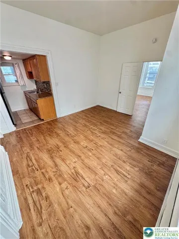 a bedroom with a bed and painting on the wall