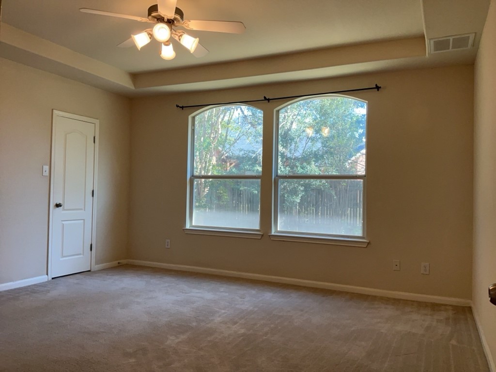 2103 Spotted Owl Circle Pflugerville, TX 78660 - Photo 11 of 24 an empty room with a window and a ceiling fan