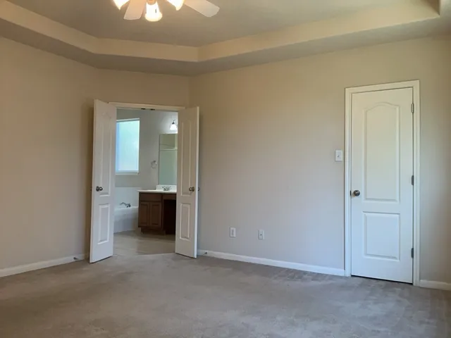 an empty room with a bathroom and a sink