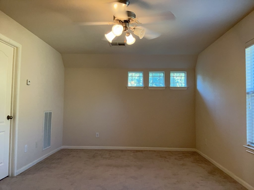 2103 Spotted Owl Circle Pflugerville, TX 78660 - Photo 16 of 24 an empty room with windows and fan