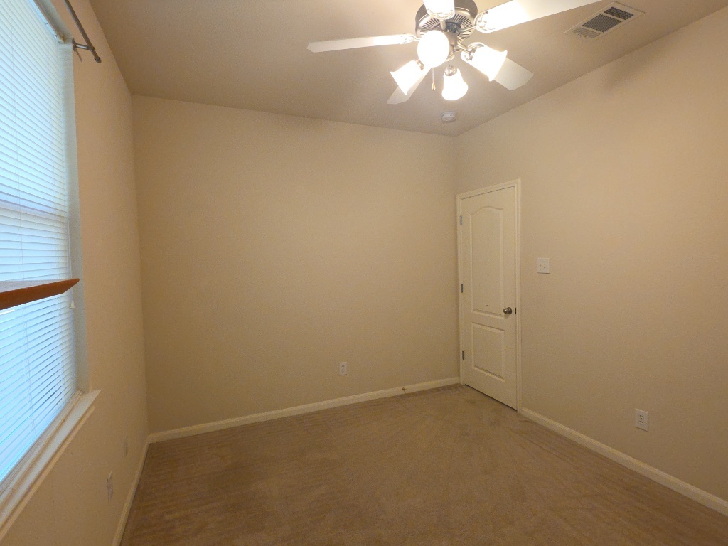 2103 Spotted Owl Circle Pflugerville, TX 78660 - Photo 21 of 24 a view of an empty room and chandelier fan