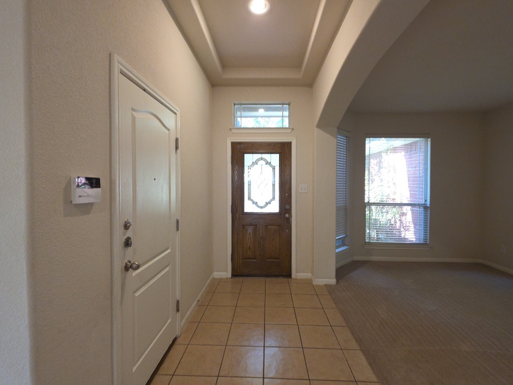 2103 Spotted Owl Circle Pflugerville, TX 78660 - Photo 3 of 24 a view of a hallway with windows
