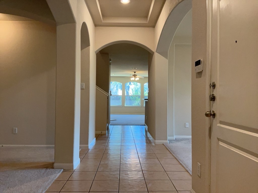 2103 Spotted Owl Circle Pflugerville, TX 78660 - Photo 6 of 24 a view of a hallway with wooden floor and a living room