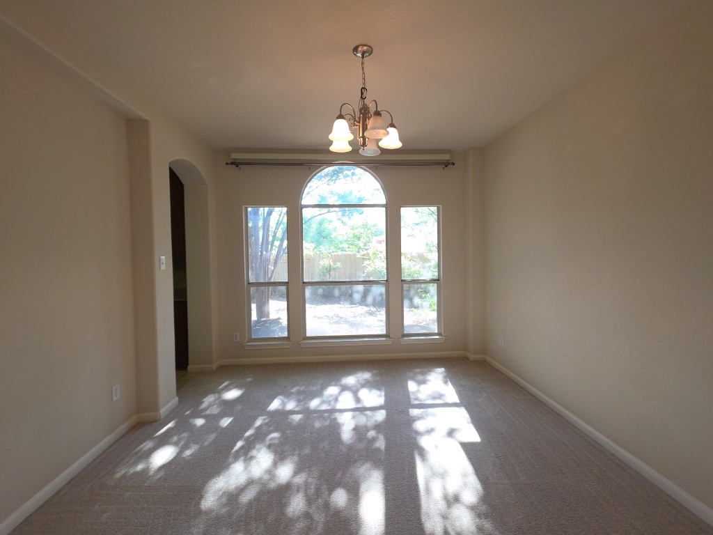 2103 Spotted Owl Circle Pflugerville, TX 78660 - Photo 7 of 24 a view of an empty room with a window