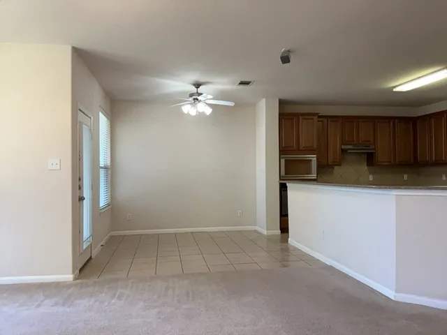 a view of a kitchen with a sink and cabinets