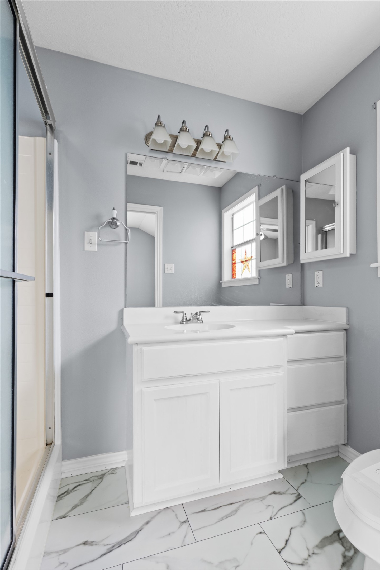 140 Meadowview Drive Trinity, TX 75862 - Photo 21 of 27 a bathroom with a sink mirror and toilet